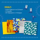 Inhalt: Anleitungsbuch mit 32 Seiten, 3 Propeller, 30 Faltpapiere in 5 Designs. Bunte Papiere und Propeller vor blauem Hintergrund.