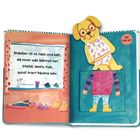 Text: "Draußen ist es nass und kalt, da muss was Warmes her: Stiefel, Weste, Pulli, sonst friert Pauline sehr."  
Illustration: Ein Hund in Unterwäsche neben einer Anziehfigur.