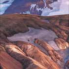 FEBRUAR. Aufgehender Mond über hügeliger Landschaft mit Schnee und Bergen.