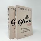 Zwei Bücher mit dem Titel "So geht Glück" von Yoo Min Ji, Untertitel: "Die verborgenen Prinzipien hinter Erfolg und Erfüllung".