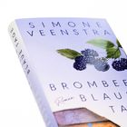 Auf einem Buchcover steht "Brombeerblaue Tage" und "Roman" von "Simone Veenstra". Es zeigt Brombeeren und Blätter.