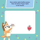 Text: "Mum möchte Apfel-Muffins backen. Male mit deinen Fingern Äpfel in den Kasten!" Illustration: Ein freundlicher Hund mit Muffins.
