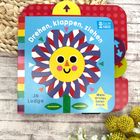 Text: "Drehen, klappen, ziehen", "Mein erstes Spielbuch", "Jo Lodge". Illustration einer fröhlichen Blume mit Gesicht.