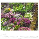 Kalenderseite für Februar 2027 mit einem Foto eines farbenfrohen Frühlingsgartens voller blühender Pflanzen.