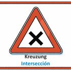 Dreieckiges Warnschild mit rotem Rand und schwarzem X. Texte: "Kreuzung" und "Intersección".