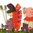 Illustration mit bunten Kreaturen, Zahlen auf Kleidung. Figuren sind fantasievoll und fröhlich in einer grünen Landschaft.