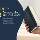Neues Jahr neues Glück. Kalender für 2027. Hand hält blauen Planer mit goldener Sonnengrafik. Florale Muster links.