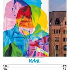 Kalenderseite für April 2027. Bunte Graffiti-Gesichter auf einer Wand neben einem Backsteingebäude.