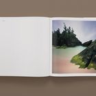 Text "Bermuda" oben links, "134" unten links. Rechts ein Foto mit felsiger Küste, klarem Wasser und Pflanzen.