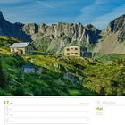 Kalenderseite: 20. Woche, Mai 2027, 17. bis 23. Hütte in Alpenlandschaft vor felsiger Bergkulisse, grünes Tal.
