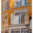 Texte an Wänden: Buchrücken, offene Bücher, Brille, zwei Vögel, "LA BIBLIOTHÈQUE DE LA CITÉ". Kalendereintrag: 23. Juni, Woche.