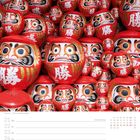 Kalenderseite mit Datum 21. bis 27. Juni, illustriert mit Daruma-Puppen. Texte: "Daruma", "25. Woche", "Juni".