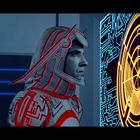 Ein Mann in einem futuristischen Anzug schaut auf ein blau-gelbes, labyrinthartiges Display.