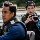 Zwei Personen in einem Boot. Eine Person hält eine Kamera mit dem "Nikon"-Logo, sie tragen Rettungswesten und blicken konzentriert.