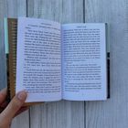 Zwei Seiten eines Buches mit Text und den Überschriften "Nina Bawden" und "Carrie's War". Eine Hand hält es.