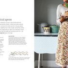 "Pretty practical apron. You're going to need... Size matters. Frau mit grünem Halsband hält Teller mit Brot, steht vor Schrank."