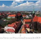 "Breslau", "3"; Aufnahme einer Stadtlandschaft mit einem Fluss, roten Dächern und Kirchen.
