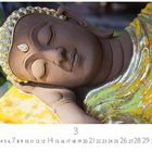 Kalenderdarstellung des Monats März mit einer ruhenden Buddha-Statue in Gold- und Brauntönen.