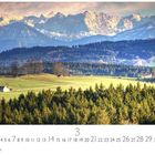 "Voralpenland", Kalenderblatt für März, zeigt sanfte Hügel mit Wiesen und einem Wald vor einer Bergkette bei Sonnenuntergang.