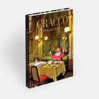 "Cracco in Galleria" auf dem Einband. Ein Clown in rotem Punktkostüm sitzt an einem elegant gedeckten Tisch.