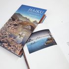 Bucheinband: "HAIKU der Jahreszeiten – Japanisch-Deutsch". Linkes Bild: Kirschblüten, Brücke, Fluss. Offene Seite mit Haiku.