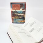 „Das Buch der klassischen Haiku“ – Ein aufgeschlagenes Buch mit Gedichten, im Hintergrund das Cover mit Landschaftsmotiv.