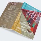 Buchcover mit dem Text: "Die Reisenden der Hankyu-Bahn". Illustration von Menschen neben einer Bahn unter Kirschblüten.