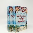 Zwei Bücher: "Winterträume im Café Nordstern" von Leonie Zenk. Cover: Wintermotiv mit Seesternen und Leuchtturm.