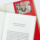 „Wer waren Ljuba und Alma? Spurensuche in Slowenien.“ Ein Buch offen auf einer Seite, darauf ein rotes Buch mit Autorenfoto.