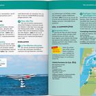 Links: Informationen zu "Essen & Trinken" und "Einkaufen". Rechts: Details zu "Stell- & Campingplätze". Untere Hälfte: Bild von einer Skulptur im Wasser, die einen gestreiften Wal mit rotem Herz darstellt.