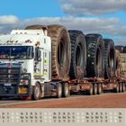 Text: „It’s all about service,“ „ROAD TRAIN“. Ein großer Lkw transportiert riesige Reifen. Kalenderdaten unten.