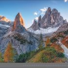 03 | MÄRZ. Beeindruckende Berglandschaft mit schroffen Felsen, farbigen Bäumen und einem klaren blauen Himmel.