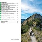 Liste von Wanderzielen mit Höhenangaben. Ein schmaler Bergpfad mit einem Hund führt zu einem Gipfel unter blauem Himmel.