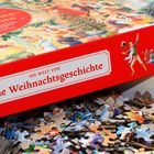 "Die Welt von Eine Weihnachtsgeschichte" auf einer roten Puzzleschachtel mit weihnachtlichen Illustrationen.