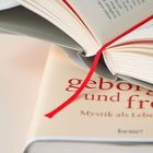Text: "geborgen und frei", "Mystik als Lebensstil". Zwei Bücher, eines geöffnet mit rotem Leseband.
