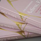 Mehrere rosafarbene Buchcover mit der Aufschrift: "Adieu, Elia" und "ELKE RUTZENHÖFER". Goldene Linien als Dekor.