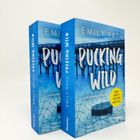 Zwei blaue Bücher, Titel: "PUCKING WILD", Autor: Emily Rath. Gelber Sticker: "Der Spicy TikTok-Erfolg".