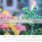 „Dein Schutzengel ist der stumme Held, der deine Sorgen in Sternenstaub verwandelt.“ Vorjahresabbildung. Ein grünes Windrad.