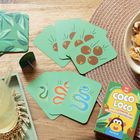 „Coco Loco - Das Kartenspiel mit fliegenden Kokosnüssen“ auf Kartenbox. Karten mit Schlangen- und Kokosnussmotiven.