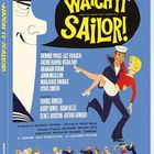 "Watch It, Sailor!" Auf blauem Hintergrund tanzen ein Matrose und eine Frau. Links ein großes Gesicht im Profil.