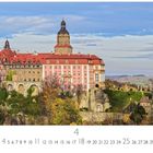 Schloss Walbrzych in herbstlicher Landschaft mit rotem Dach und einem großen Turm. Im Hintergrund Hügel und blauer Himmel.