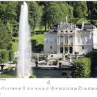 Schloss Linderhof, Oberammergau. Ein elegantes Schloss mit Brunnen und gepflegten Gärten, umgeben von üppigem Grün.