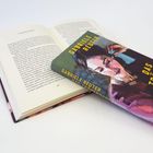 Text: "Sechzehntes Kapitel", "Gabriele Reuter", "Das Tränenhaus". Ein Buch mit Illustration einer nachdenklichen Frau.