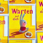 „Warten auf dich“ in großen, pinken Buchstaben. Ein Hase sitzt neben einem Teller mit Keksen.