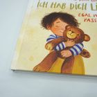 Text: "Ich hab dich lieb, egal was passiert." Illustration: Ein Kind umarmt einen Teddybär, lächelnd vor einem gelben Hintergrund.