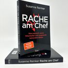 Buchtitel: "Rache am Chef". Autorin: Susanne Reinker. "SPIEGEL Bestseller-Autorin". Verlagsname: Econ. Ein Buch steht aufrecht.