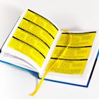 Ein aufgeschlagenes Buch mit gelbem Hintergrund und schwarzem Text: Tabellen zeigen Daten für Zahnsteinentfernung, Haare, Fensterputzen. Ein gelbes Leseband ist sichtbar.