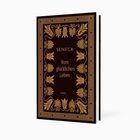 "Seneca, Vom glücklichen Leben, INSEL" steht auf einem Buch mit einem goldenen Ornamentrahmen auf dunklem Hintergrund.