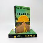 Buchcover „KURT PRÖDEL KLAPPER“. Abgebildet: Halbierte Orange als Sonnenuntergang über einer Straße, Ullstein Verlag.