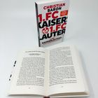 "CHRISTIAN BARON 1. FC KAISERSLAUTERN." Ein Buchcover, das Buch steht aufrecht, unten ein geöffnetes Buch auf den Seiten 122 und 123.